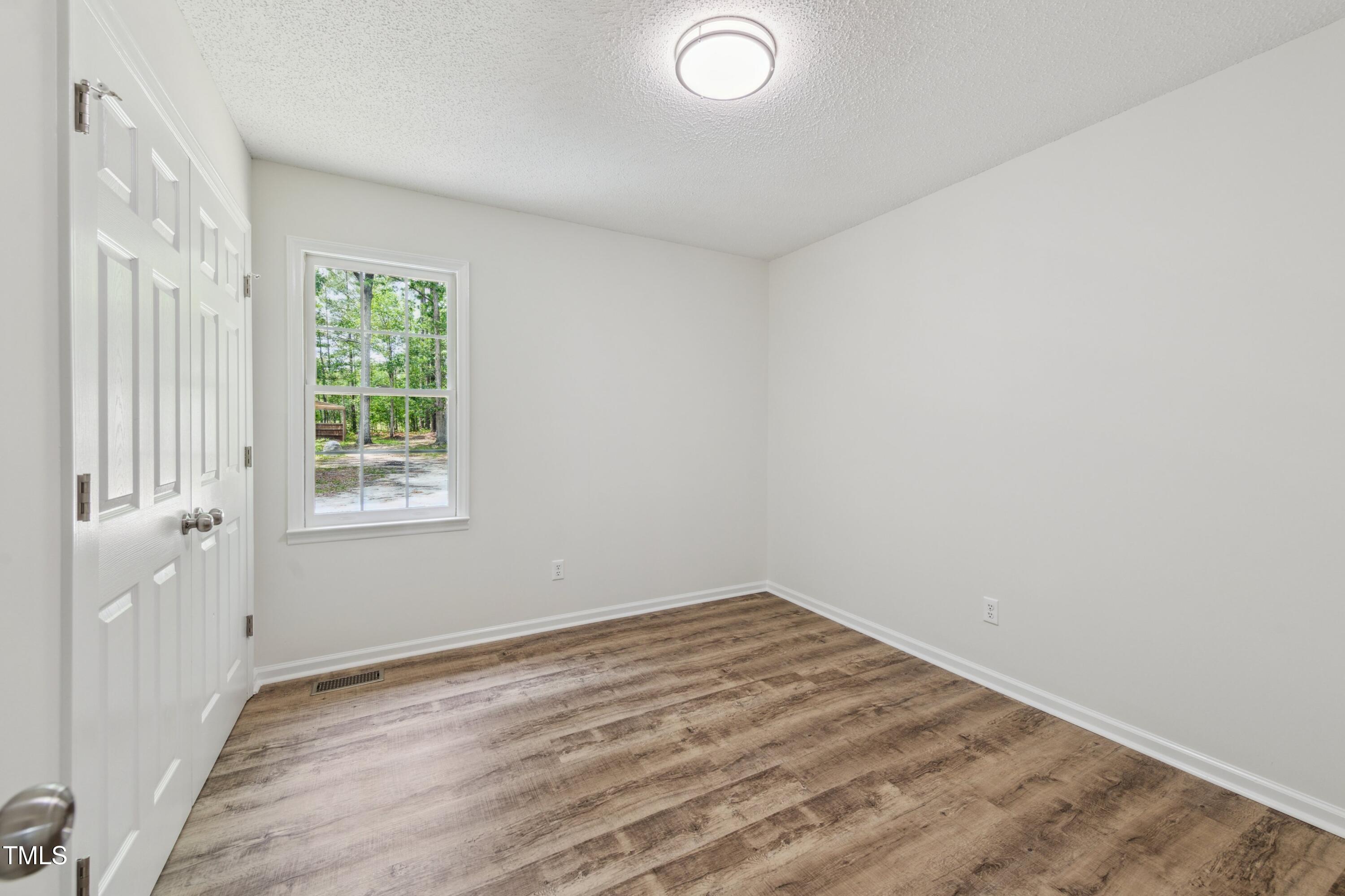 856 Williams-White Road Zebulon, NC 27597 - Photo 15 of 38 an empty room with a window