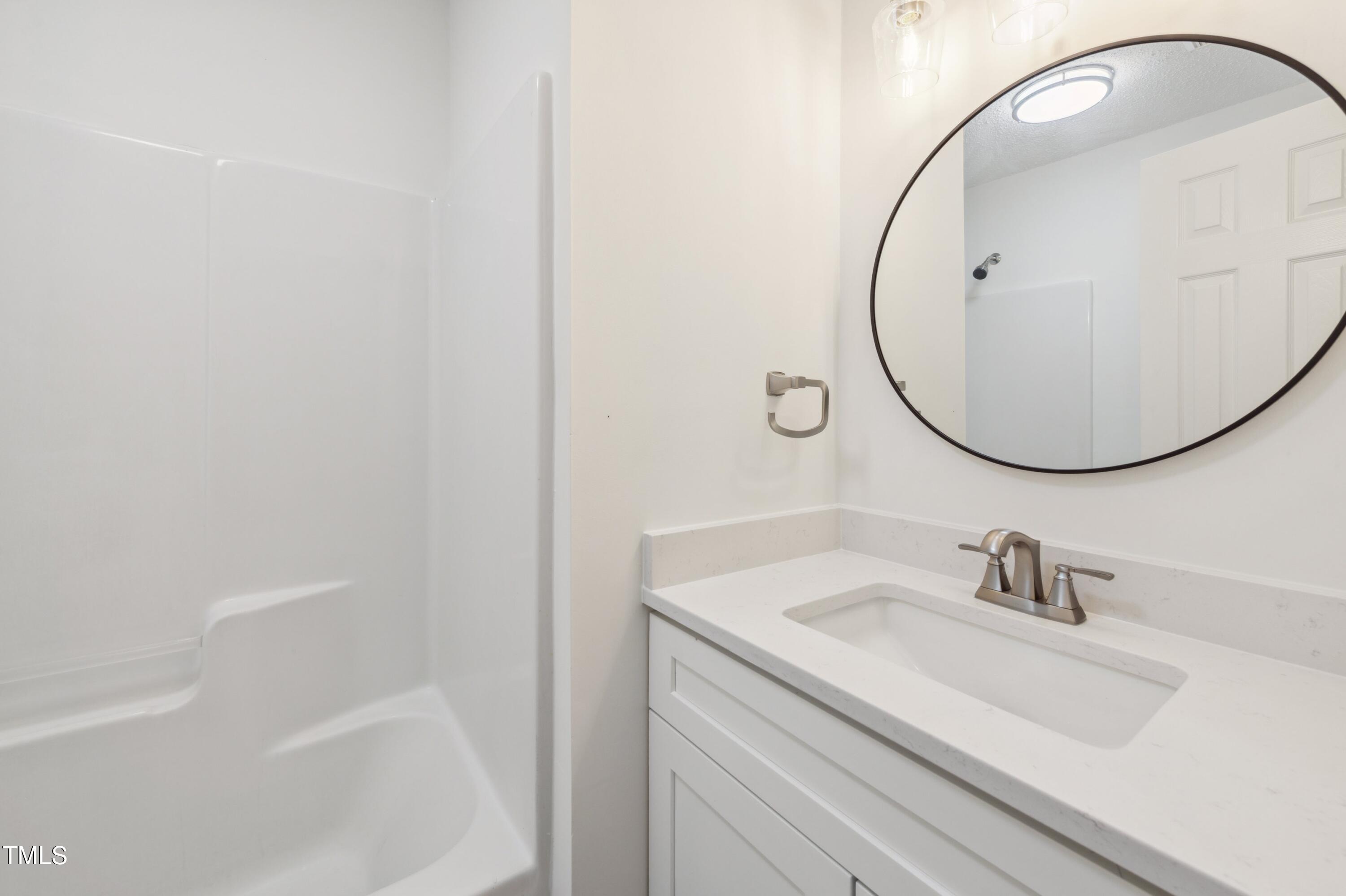856 Williams-White Road Zebulon, NC 27597 - Photo 21 of 38 a bathroom with a sink and a mirror
