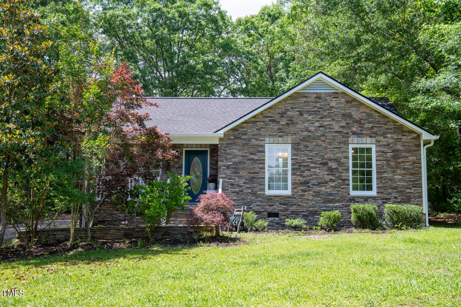 856 Williams-White Road Zebulon, NC 27597 - Photo 28 of 38 a front view of a house with a yard and garage