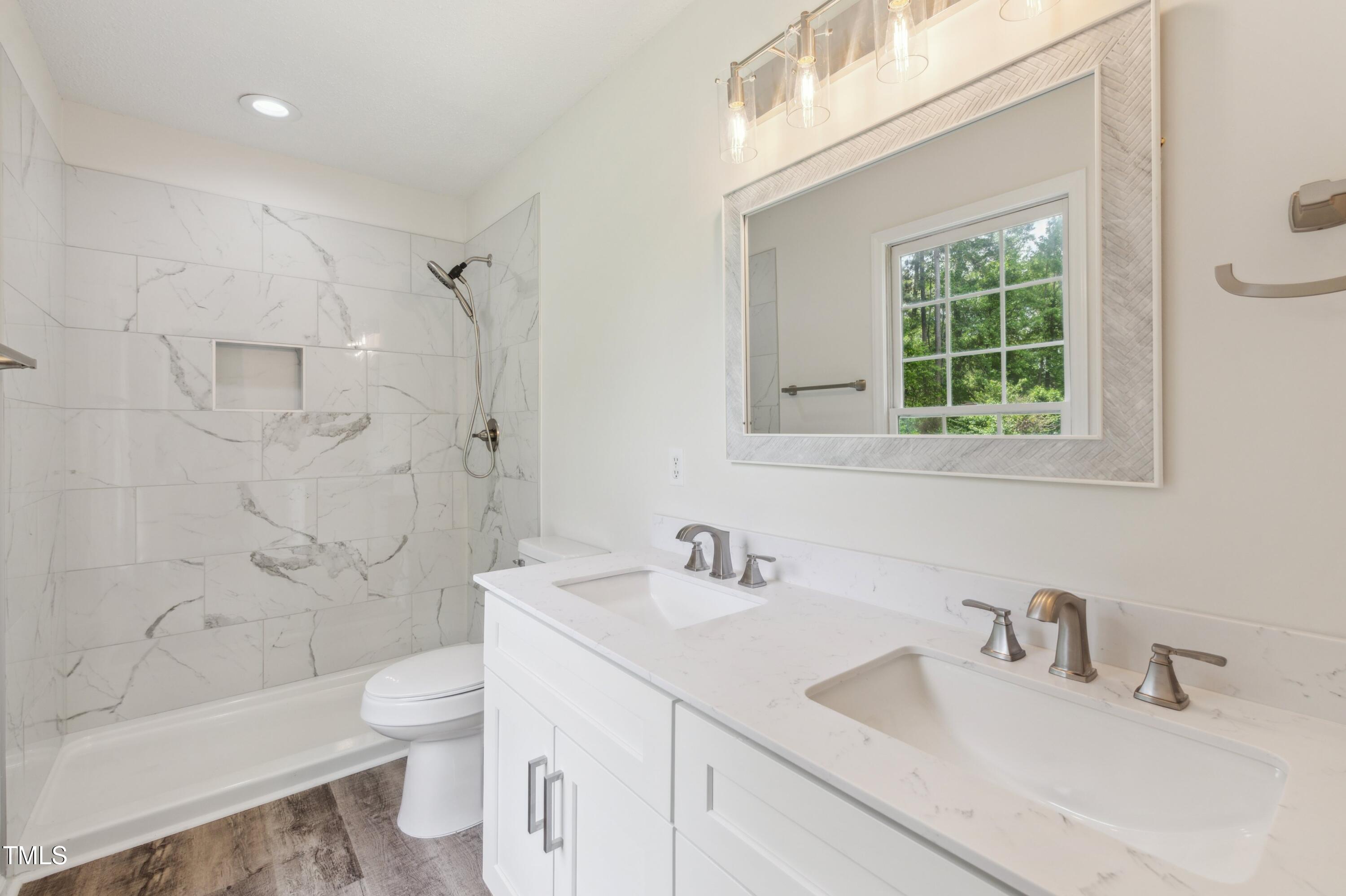 856 Williams-White Road Zebulon, NC 27597 - Photo 7 of 38 a bathroom with a sink toilet vanity and shower