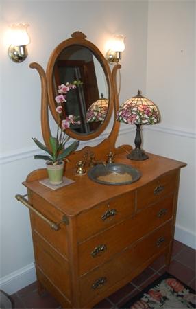 25 Winthrop Road Lexington, MA 02421 - Photo 13 of 16 a bathroom with a sink a mirror and vanity