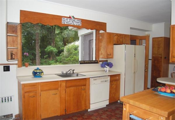 25 Winthrop Road Lexington, MA 02421 - Photo 10 of 16 a kitchen with stainless steel appliances a sink and a refrigerator