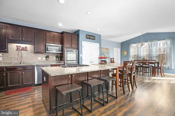 a dining room with furniture and wooden floor