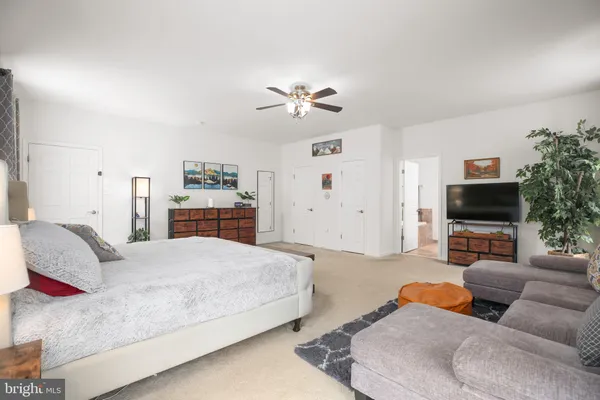 a bed room with a bed and a chair