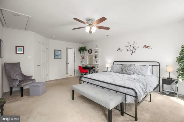 a living room with furniture kitchen view and a wooden floor