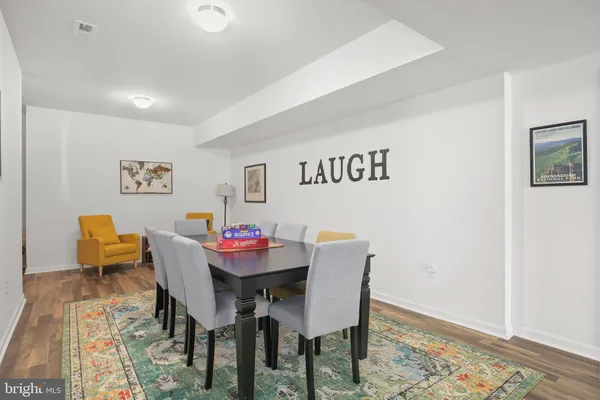 a big white house with a big yard and potted plants