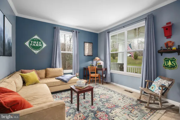 a dining hall with stainless steel appliances granite countertop a table chairs and a large window