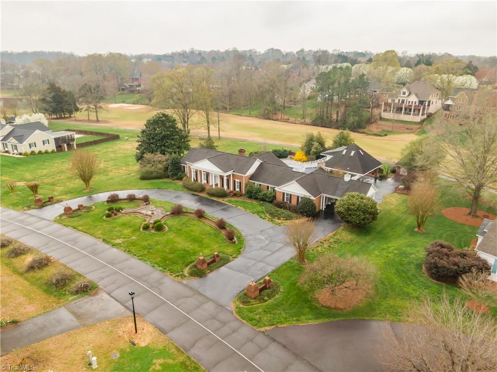 The circle drive and professionally designed landscaping, the home and the golf course from a bird's eye view.