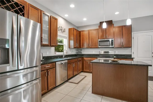 a bathroom with a granite countertop sink a toilet and shower