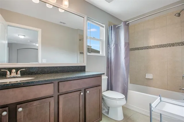 a living room with furniture a wooden floor and a window