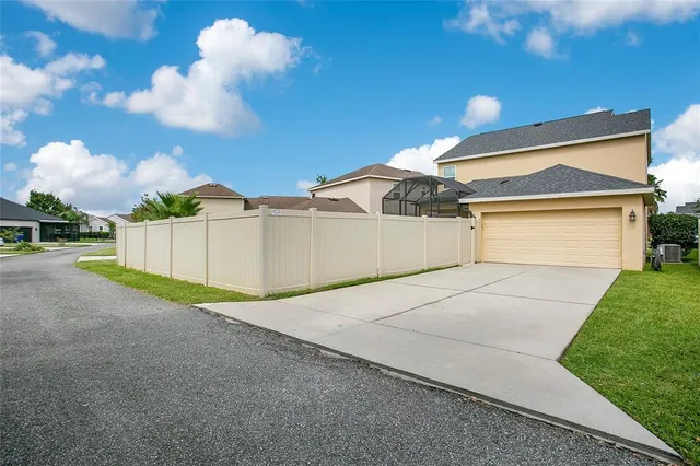 a view of a house with a yard and garage