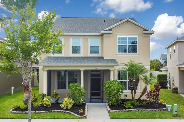 a view of a patio with swimming pool lawn chairs and a fire pit