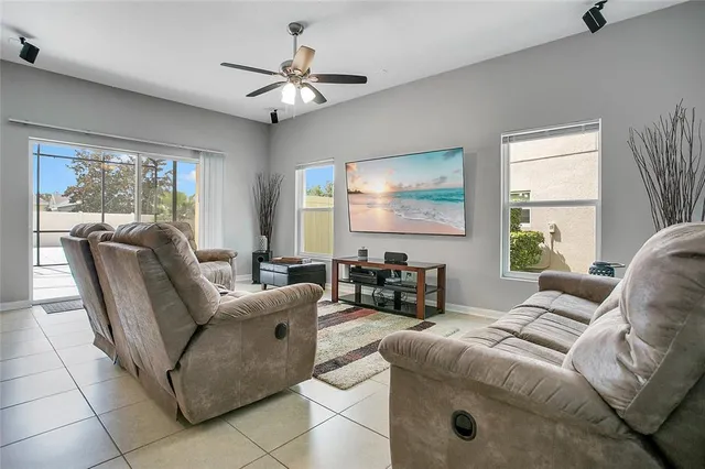a living room with furniture and a chandelier
