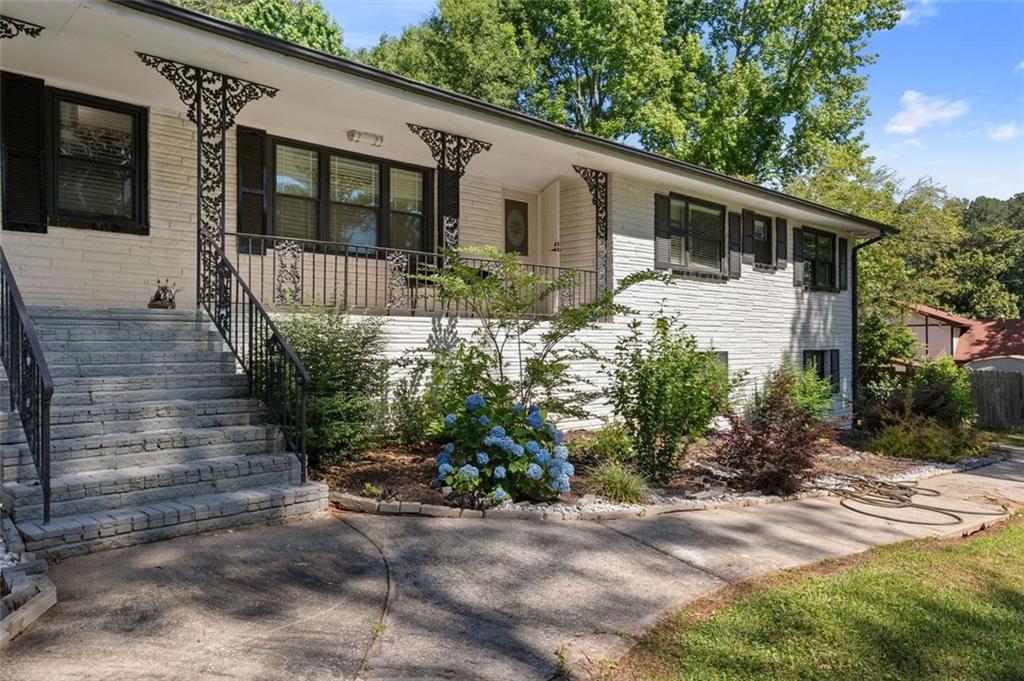 a front view of a house with garden