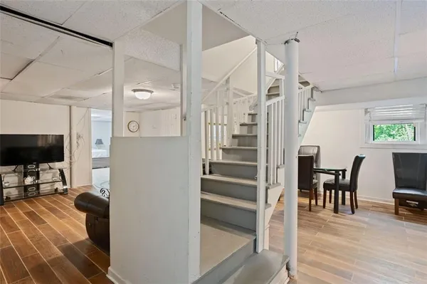 a view of a livingroom with furniture and a flat screen tv