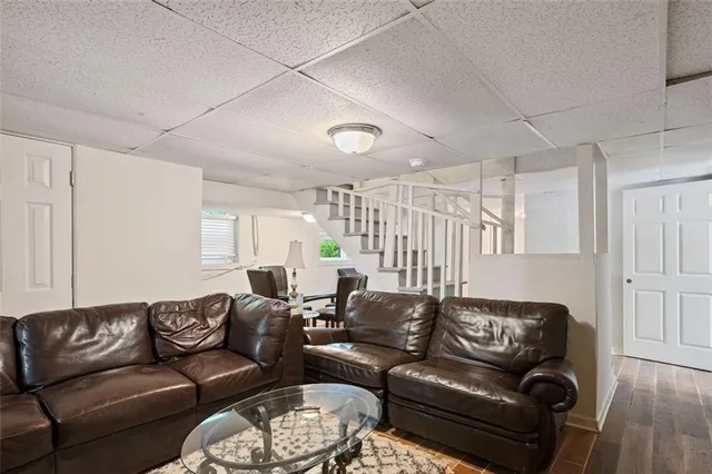 a living room with furniture a ceiling fan and a window