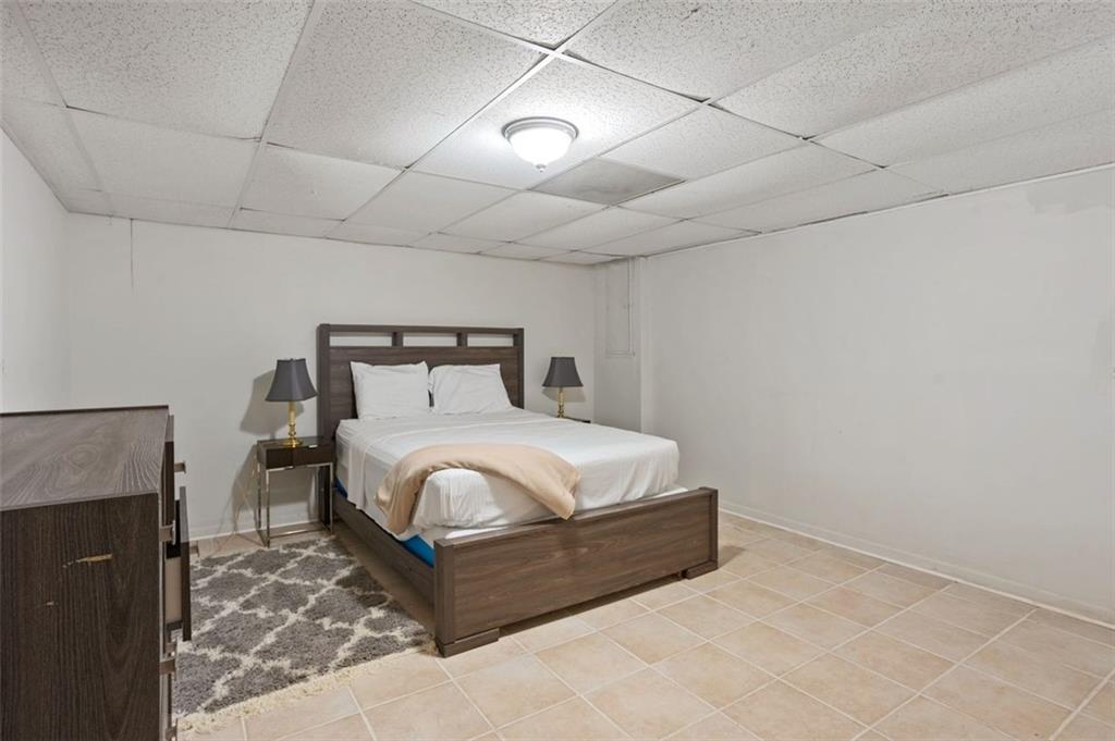 3501 Wesley Chapel Road Decatur, GA 30034 - Photo 18 of 20 a bedroom with a bed and a fireplace