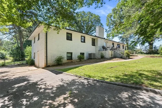 a view of a white house with a yard