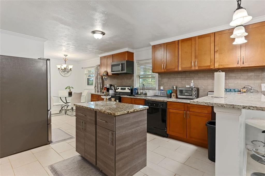 3501 Wesley Chapel Road Decatur, GA 30034 - Photo 3 of 20 a kitchen with stainless steel appliances granite countertop a stove top oven a sink a refrigerator and cabinets