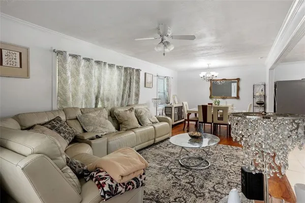 a living room with furniture a couch and a flat screen tv