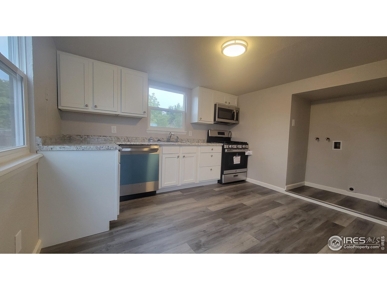 109 4th Street Gilcrest, CO 80623 - Photo 3 of 22 a kitchen with a sink cabinets and window
