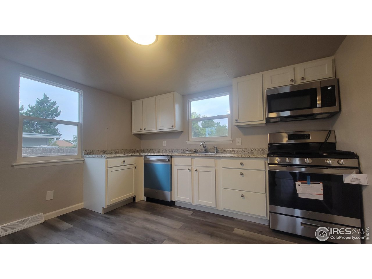 109 4th Street Gilcrest, CO 80623 - Photo 5 of 22 a kitchen with a sink a microwave and cabinets