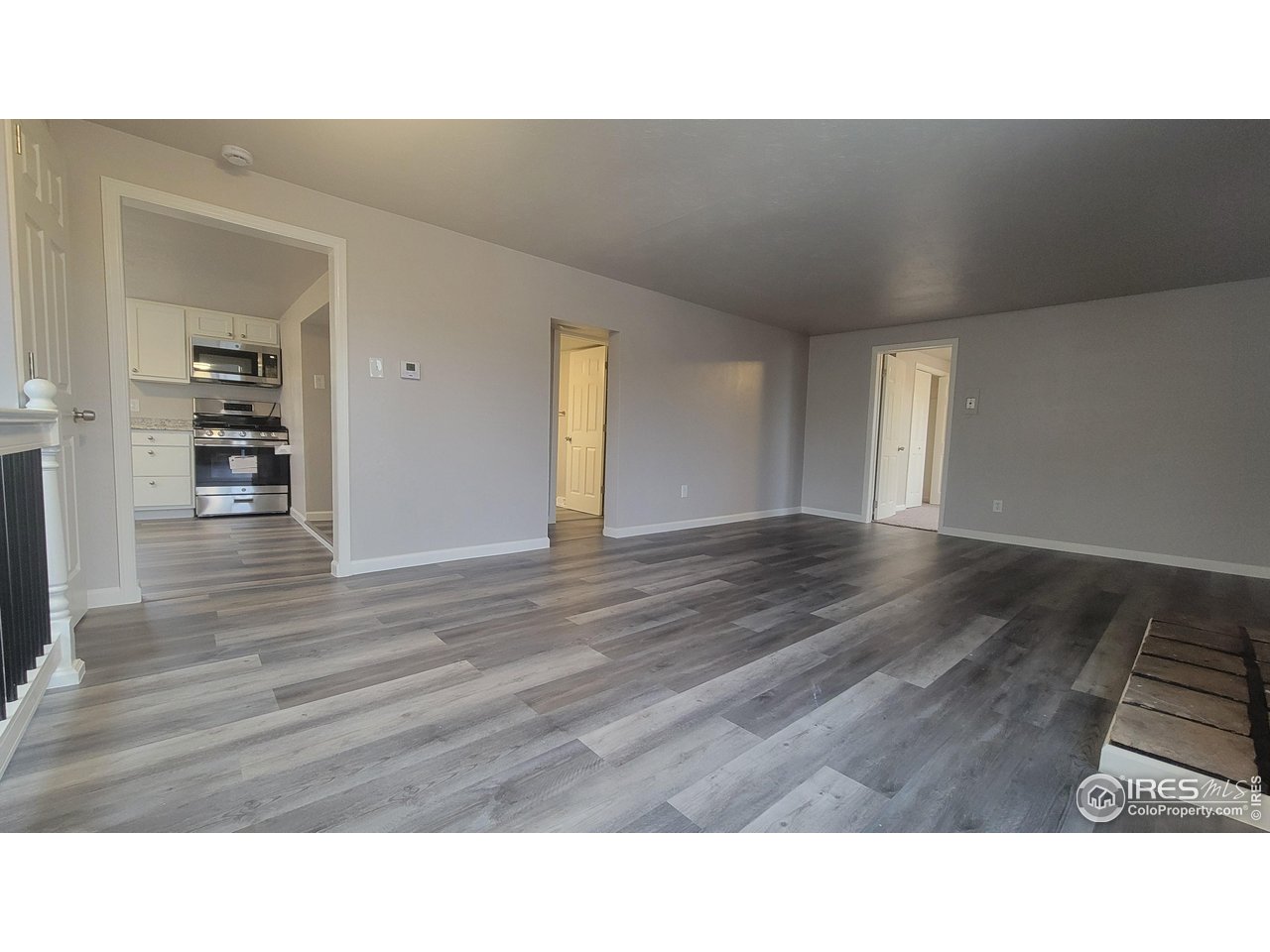 109 4th Street Gilcrest, CO 80623 - Photo 7 of 22 a open hall with wooden floor
