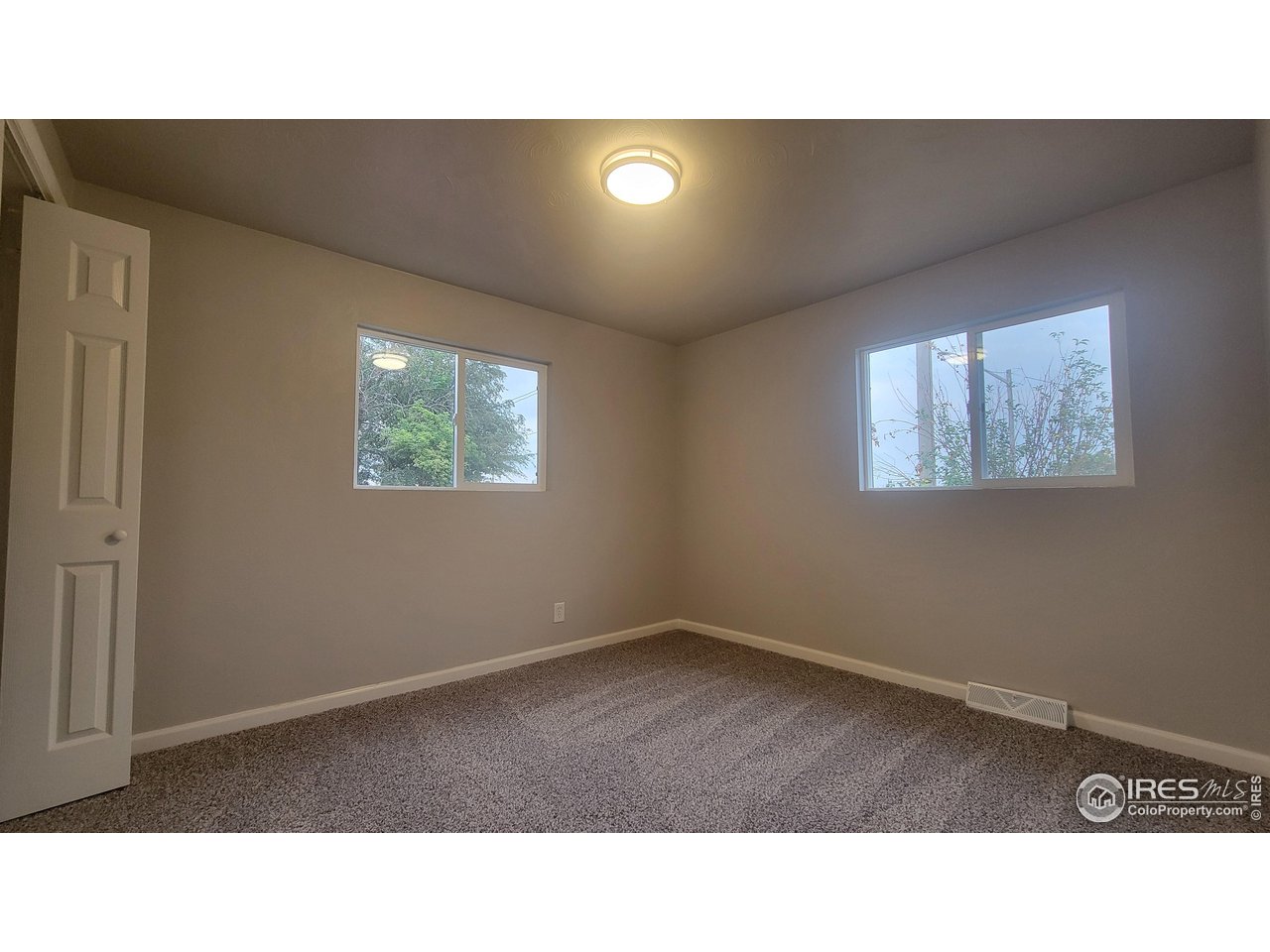 109 4th Street Gilcrest, CO 80623 - Photo 9 of 22 a open hall with a floor to ceiling window and a flat screen tv