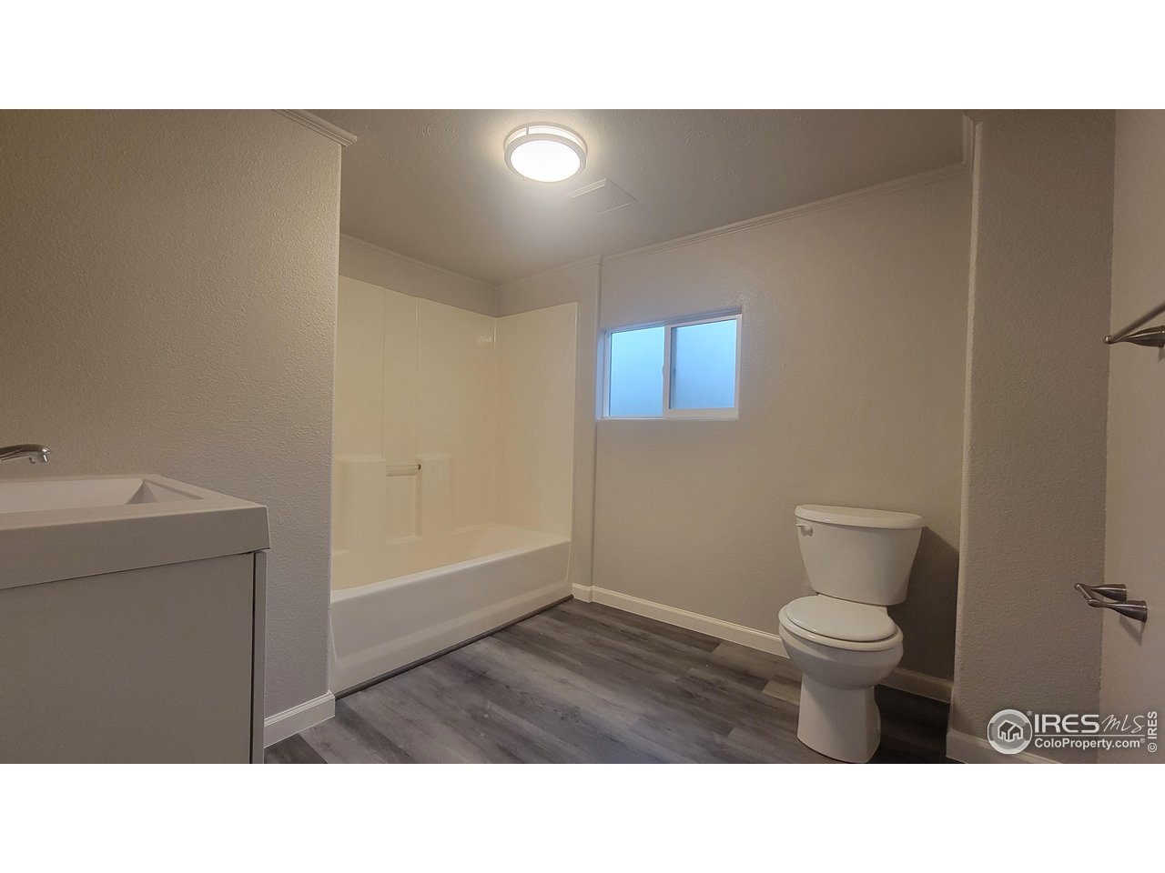 109 4th Street Gilcrest, CO 80623 - Photo 10 of 22 a bathroom with a toilet and a sink