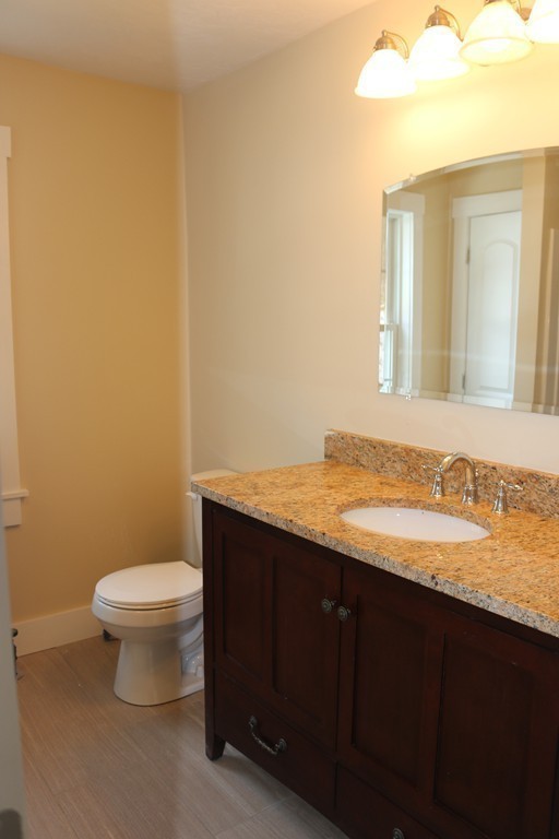 181 Westboro Road Upton, MA 01568 - Photo 11 of 15 a bathroom with a granite countertop sink and a toilet