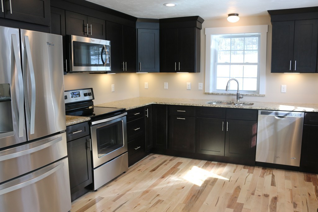 181 Westboro Road Upton, MA 01568 - Photo 3 of 15 a kitchen with a sink stove and refrigerator