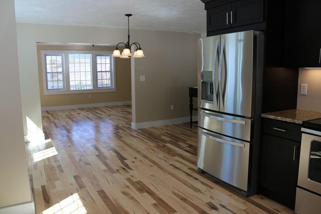 181 Westboro Road Upton, MA 01568 - Photo 4 of 15 a kitchen with stainless steel appliances granite countertop a refrigerator and a stove top oven