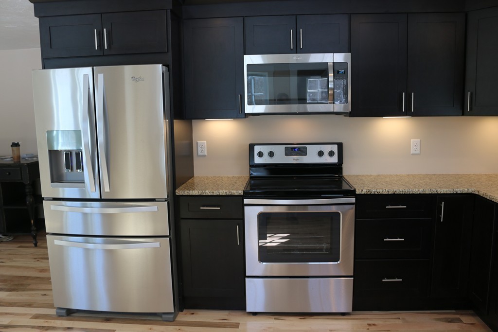 181 Westboro Road Upton, MA 01568 - Photo 5 of 15 a kitchen with a refrigerator stove and microwave