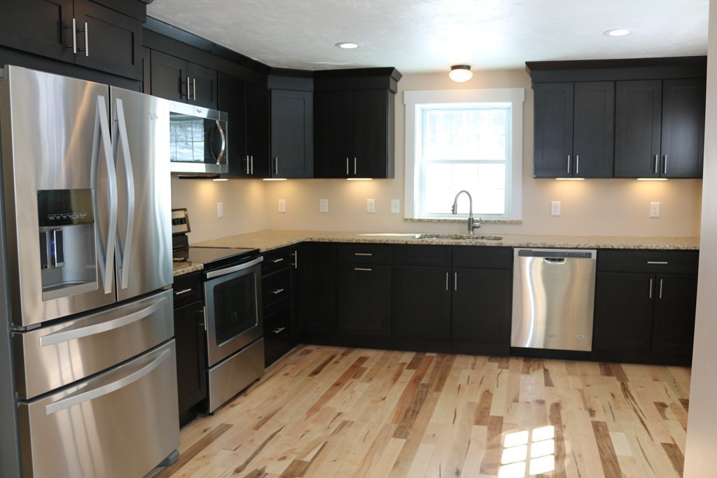 181 Westboro Road Upton, MA 01568 - Photo 6 of 15 a kitchen with granite countertop stainless steel appliances and wooden cabinets