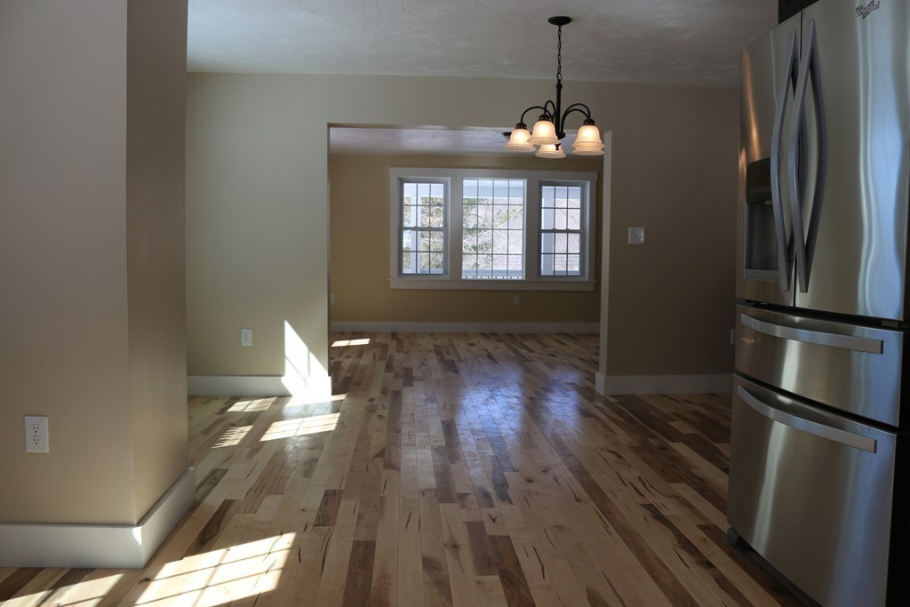 181 Westboro Road Upton, MA 01568 - Photo 7 of 15 a view of a room with wooden floor fridge and a window