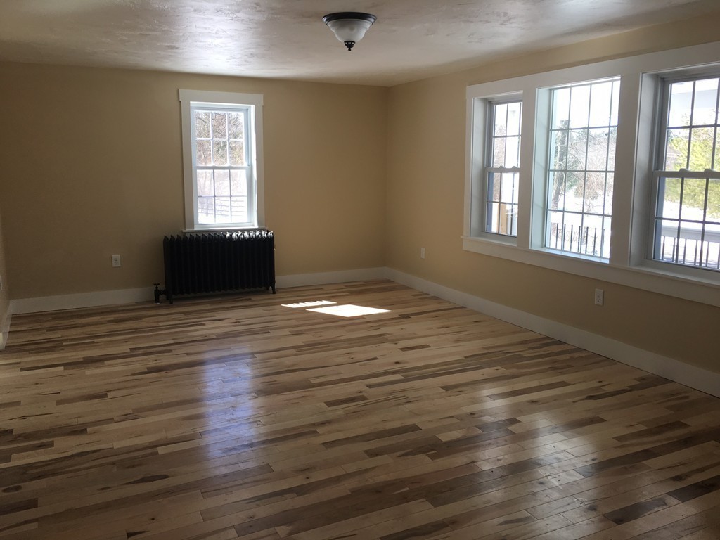 181 Westboro Road Upton, MA 01568 - Photo 10 of 15 an empty room with wooden floor and windows
