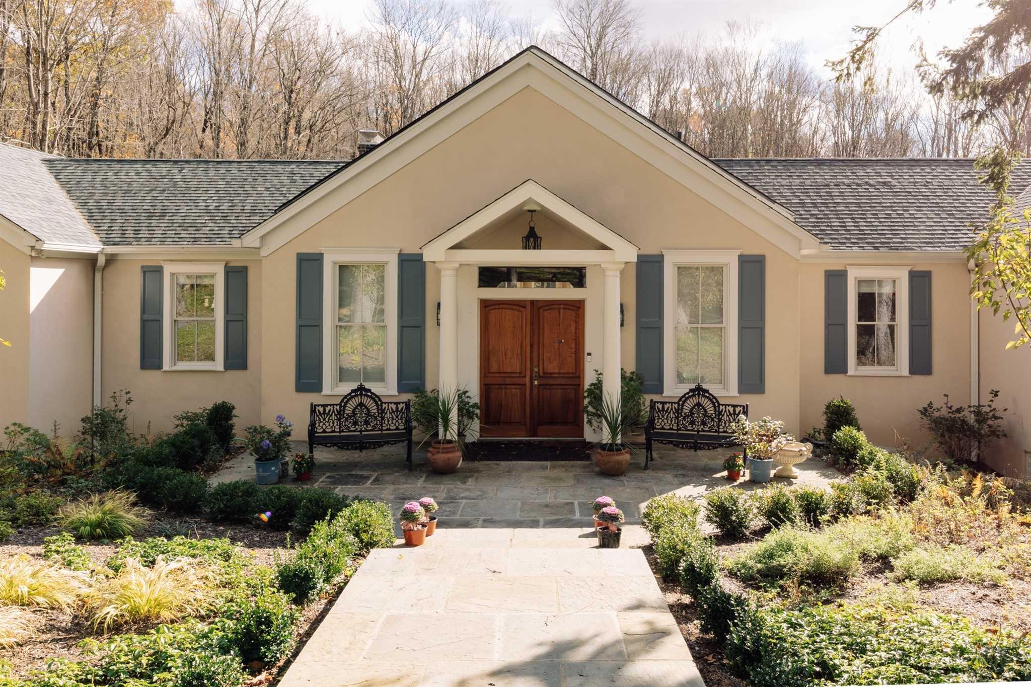 a view of a house with yard and sitting area