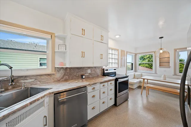 a kitchen with a sink stove and cabinets