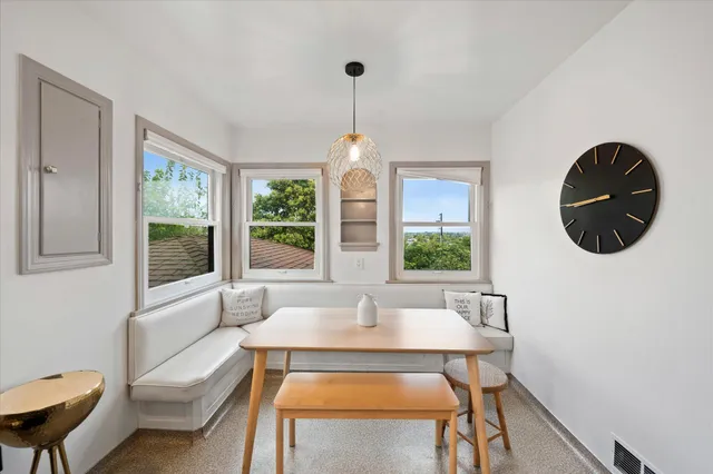 a living room with furniture a table and a large mirror next to a window