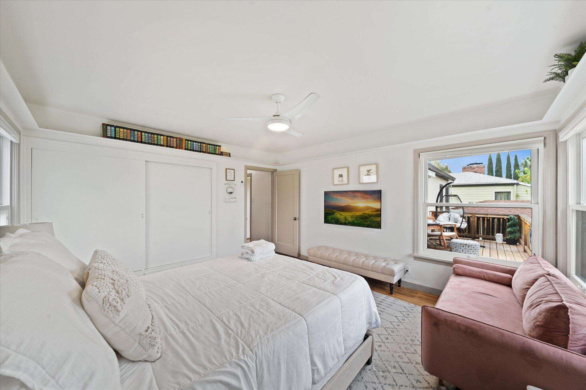 1901 Chestnut Street Redding, CA 96001 - Photo 15 of 39 a bedroom with a balcony a bed and a flat screen tv