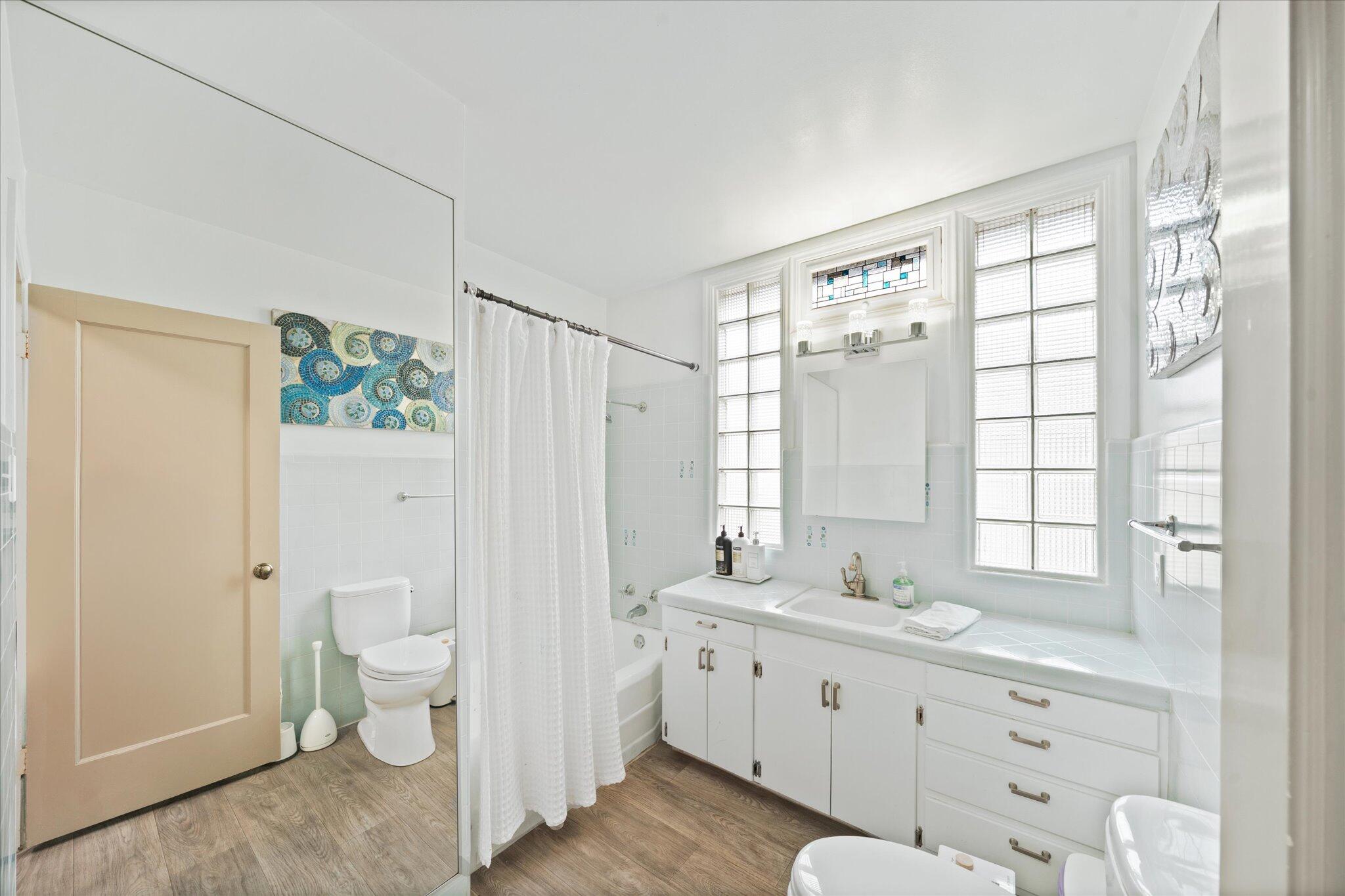 1901 Chestnut Street Redding, CA 96001 - Photo 21 of 39 a spacious bathroom with a double vanity sink a toilet and a shower