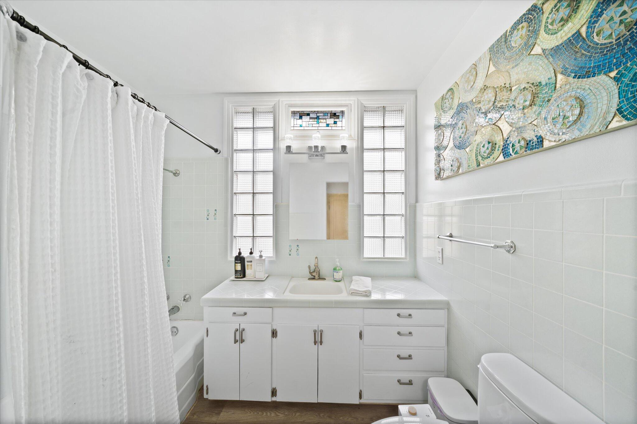 1901 Chestnut Street Redding, CA 96001 - Photo 22 of 39 a bathroom with a granite countertop sink a toilet and a large mirror