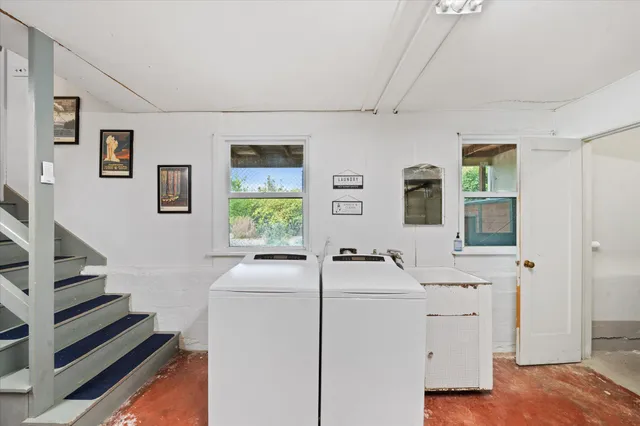 a room with two washing machine and sink