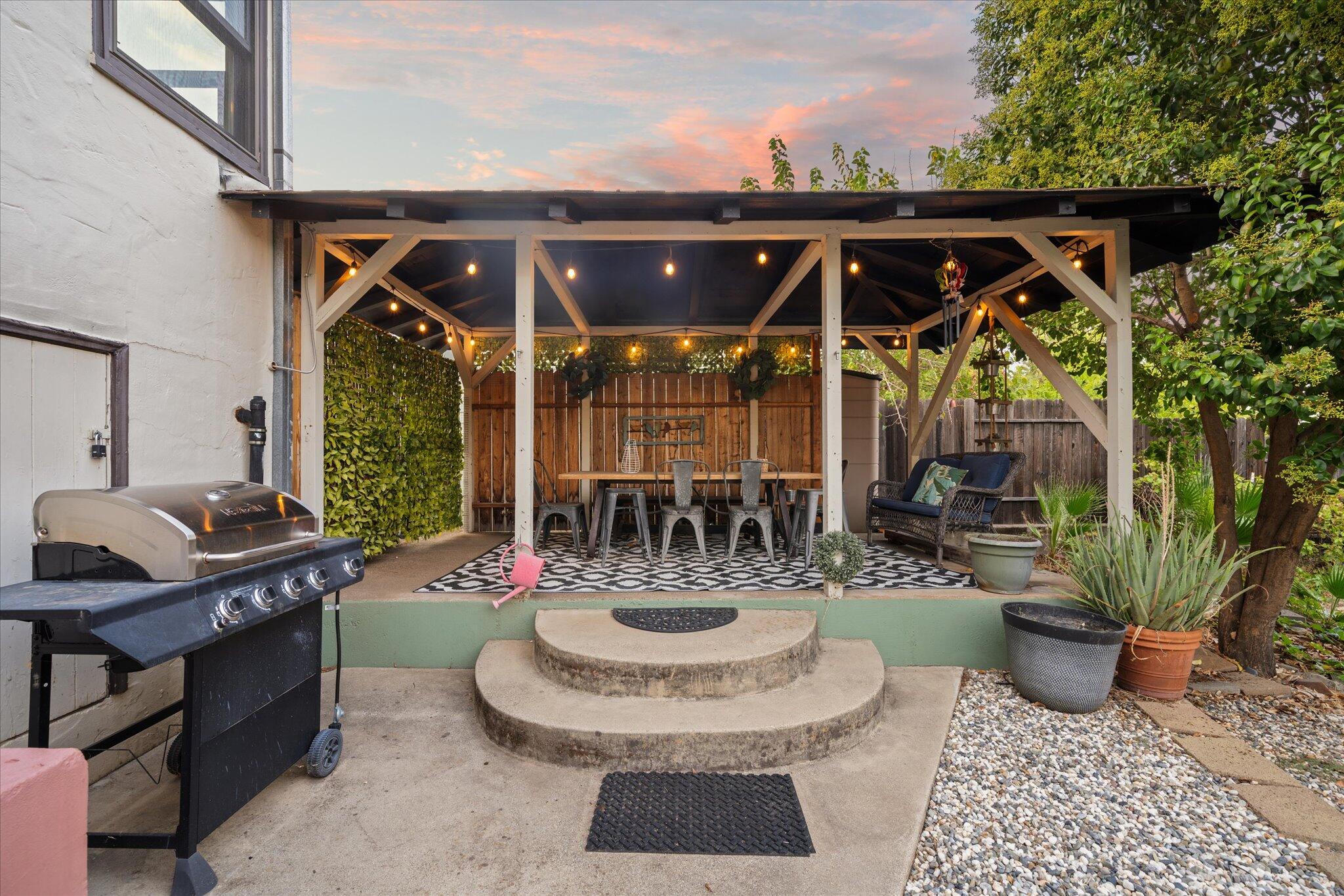 1901 Chestnut Street Redding, CA 96001 - Photo 34 of 39 a view of a patio with table and chairs potted plants and palm tree