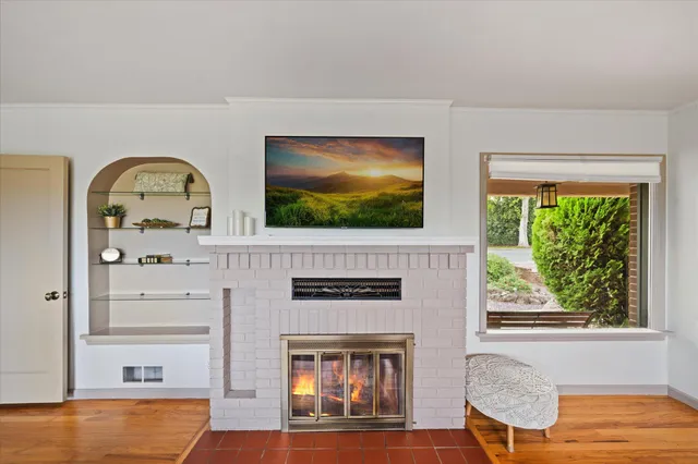 a living room with flat screen tv and a fireplace