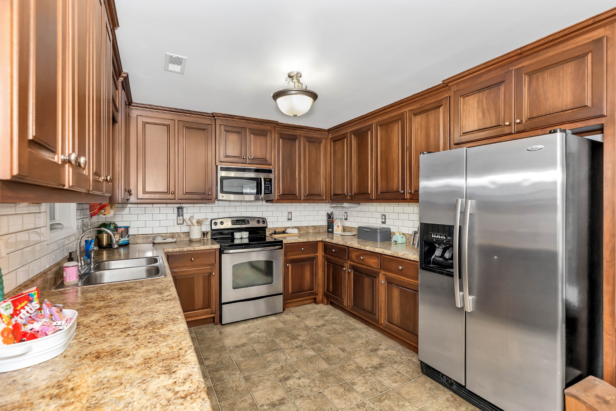 25518 Clem Road Elkmont, AL 35620 - Photo 8 of 24 a kitchen with granite countertop stainless steel appliances and wooden cabinets