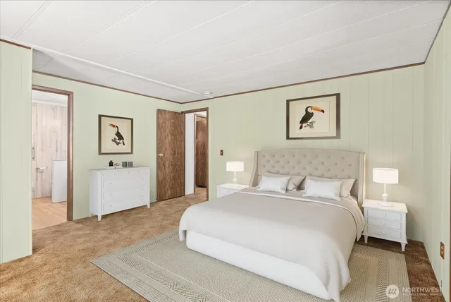 a bedroom with a bed and a painting on the wall