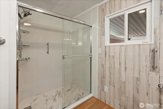 a bathroom with a glass shower door