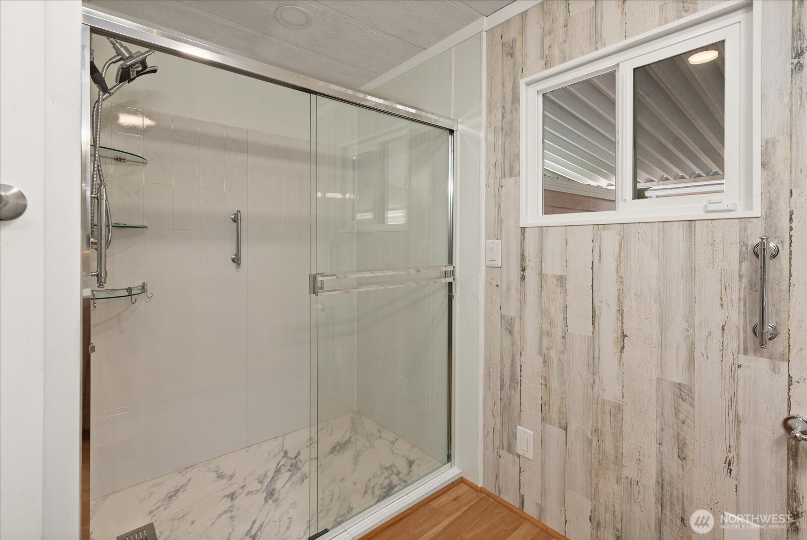815 124th Street Southwest, Unit 133 Everett, WA 98204 - Photo 15 of 38 a bathroom with a glass shower door