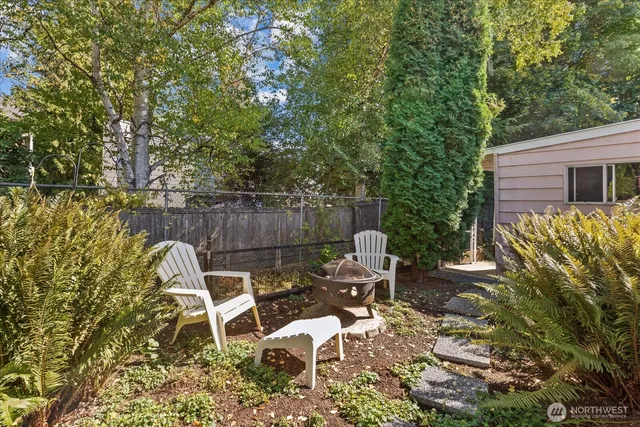 a view of a chairs and table in backyard